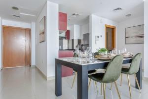 a dining room and kitchen with a table and chairs at Frank Porter - Ocean Heights in Dubai