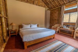 a bedroom with a large bed in a room at HABITAS RHINO BY NATURE HUNT in Kāziranga +36 photos