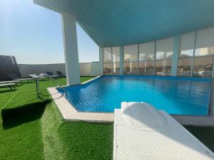 a large swimming pool in a building at Wakra Inn Hotel Apartments in Al Wakrah