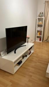 a living room with a large flat screen tv at Appartement frontière Luxembourg in Thionville