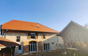 an old stone house with an orange roof at Au Coin Du Chemin in Chambéry