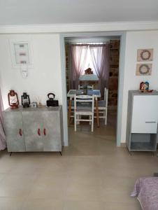 a living room with a table and a dining room at Dora's house in Katarráktis