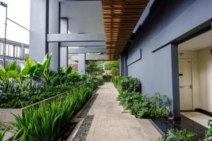 an internal courtyard of a building with plants at 2 Master 5 Min To D1 Pool & Bbq in Ho Chi Minh City