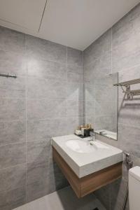 a bathroom with a sink and a toilet at Compassone - 2bd Luxury Apartment Free Gym & Pool in Ấp Phú Thọ