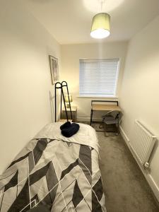 a bedroom with a bed and a window at Fairway Villa in Stafford