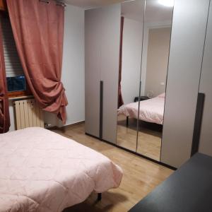 a bedroom with a mirror and a bed in it at Da Debbyquattro in Pisa