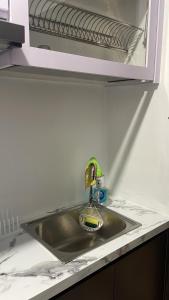 a kitchen sink with a faucet and a mirror at Formosa Residence Apartment Nagoya Batam 15th Free Netflix in Jodoh +8 photos