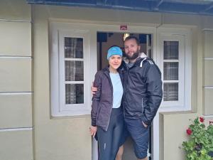 a man and a woman standing in front of a house at Ruchi House in Nuwara Eliya