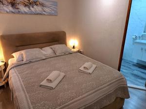 a bedroom with a bed with two towels on it at Villa Ivan in Dubrovnik