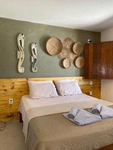 a bedroom with a bed with numbers on the wall at Aldeia Patacho in Pôrto de Pedras