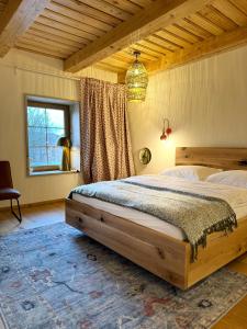 a bedroom with a large bed in a room at Zajazd Hubert in Walim