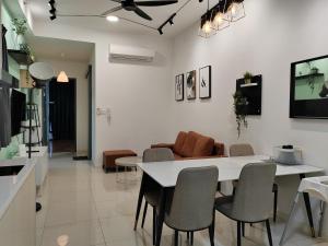 a kitchen and living room with a table and chairs at Paradigm Residence in Johor Bahru