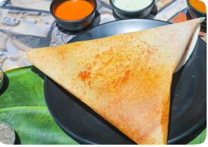 a tortilla sitting on a plate on a table at Hotel Dosa plaza in Udaipur