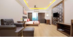 a hotel room with a bed and a television at Yashshree Milestone in Siliguri