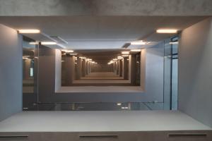 a reflection of a hallway in a mirror at Sea Star Budva in Budva