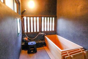 baño pequeño con bañera y ventana en しまなみ宿Gyoku en Imabari