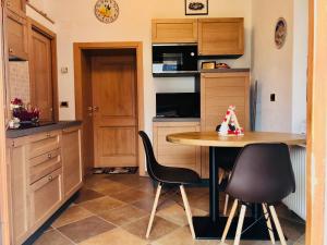 a kitchen with a table and two chairs in it at Residence Dolomiti in Forni di Sopra +34 photos