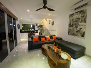 a living room with a couch and a table at Villa Mabuk in Legian