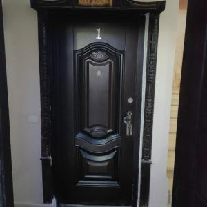 a black door with a cross on top of it at Hurghada City Apartment1 in Hurghada +12 photos