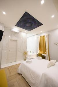 - une chambre avec un grand lit blanc et une douche dans l'établissement Enchanting Suites Salerno, à Salerne