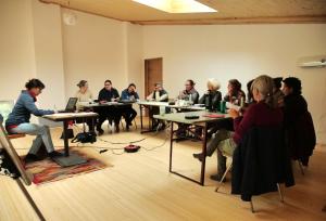 a group of people sitting at tables in a room at Métairie de Lamourade - Un écrin de nature sereine in Saint-Ferriol