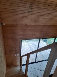 Cette chambre dispose d'une grande fenêtre et d'un plafond en bois. dans l'établissement Cabaña nórdica en la naturaleza, à Punta Ballena