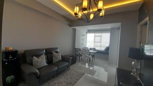 a living room with a couch and a table at Ruby Apartment #23 in Yogyakarta
