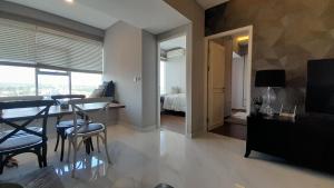 a living room with a dining table and a bedroom at Ruby Apartment #23 in Yogyakarta