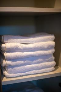 a stack of white towels sitting on a shelf at Lux apartment Zlatni Javor Jahorina in Jahorina