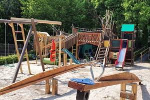 a playground with a wooden slide in the sand at Het mooiste vakantiehuisje in Durbuy in Durbuy