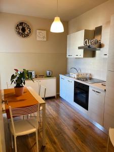 a kitchen with a table and a dining room at Sweet Home in Pisa