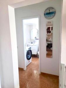 a bathroom with a sink and a washing machine at Apartamento Lory-Puerto del Carmen in Tías +19 photos