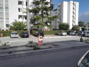 a street with cars parked in a parking lot at Sweet Home in Pisa