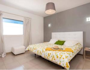 a bedroom with a bed with a hat on it at Villa Arcelia in Puerto del Carmen +30 photos