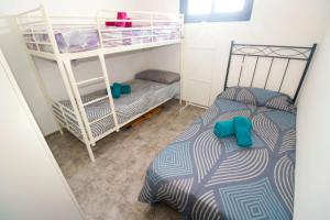 a bedroom with two bunk beds and a bed at Dúplex Vista Mar Puerto Del Carmen in Puerto del Carmen