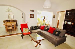 a living room with a couch and a table at Luxury Villa Alfred in Puerto del Carmen