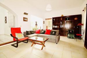 a living room with a couch and a coffee table at Luxury Villa Alfred in Puerto del Carmen