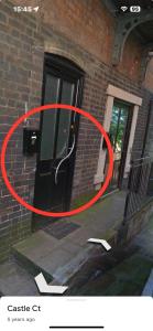 a red circle on a door of a brick building at Casa Amor Homes in Shrewsbury
