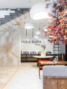 a restaurant with a wall with a sign that reads villa elena at Elena Spa Resort in Bukovel
