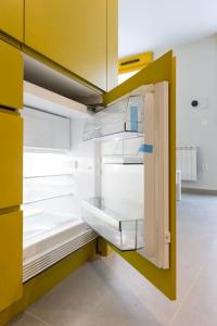 an empty refrigerator with its door open in a kitchen at Estudio moderno y acogedor en Madrid Rio nº1 in Madrid