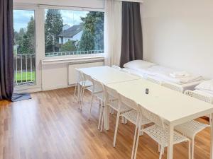 a room with tables and chairs and a large window at T&K Apartments - Erkrath - 4 Zimmer Apartments in Erkrath