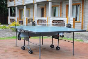 a ping pong table in front of a house at Nester House in Svityazʼ