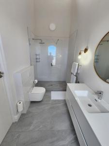 a white bathroom with a sink and a toilet at Villa Moselle - St James in St. James