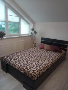 a bedroom with a bed with a leopard print mattress at Family Apartments Lviv Villa OLGA in Lviv