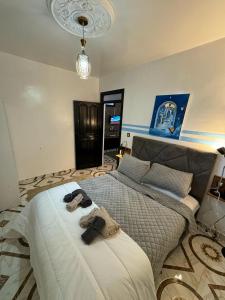 a bedroom with a large bed with towels on it at Dar Saphire in Chefchaouen +21 photos