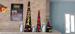 three christmas trees sitting on a shelf in a room at Mamado PYRAMIDS VIEW in Cairo