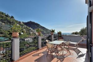 a patio with a table and chairs on a balcony at Villa Anna in Minori