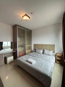 a bedroom with a large bed in a room at Comfy 1BR At Central ( City View ) in Jakarta