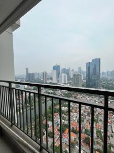 a view of the city from a balcony at Comfy 1BR At Central ( City View ) in Jakarta