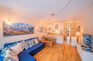 a living room with a blue couch and a table at Apartment Arve in Chamonix-Mont-Blanc